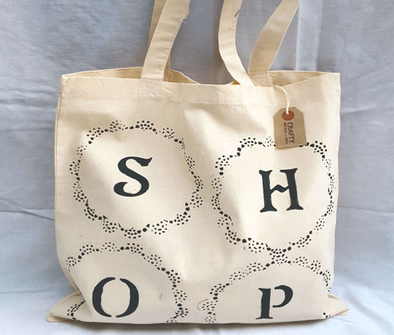 A Natural Cotton Tote Shoulder Bag with a Circular Pattern Shop Design in Black