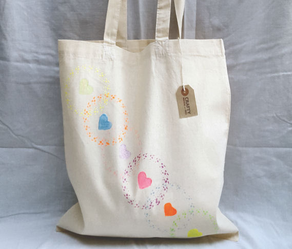 A Natural Cotton Tote Shoulder Bag with a Circle and Heart Rainbow Effect Pattern Design