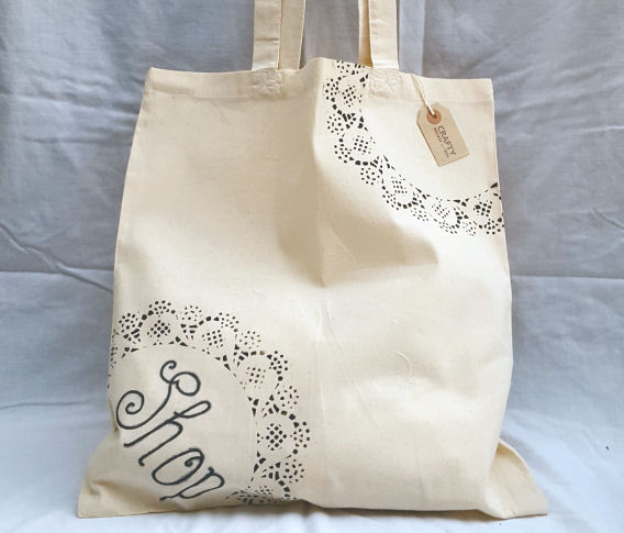 A Natural Cotton Tote Shoulder Bag with a Shop and Black Pattern Design