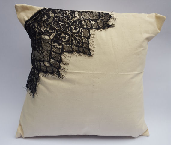 A Natural Calico Cushion with a Black Lace Corner Design