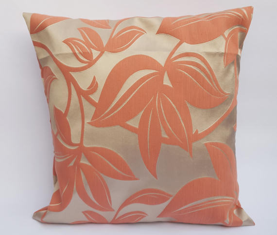 A Handmade Floral Cushion in Coral on Beige.