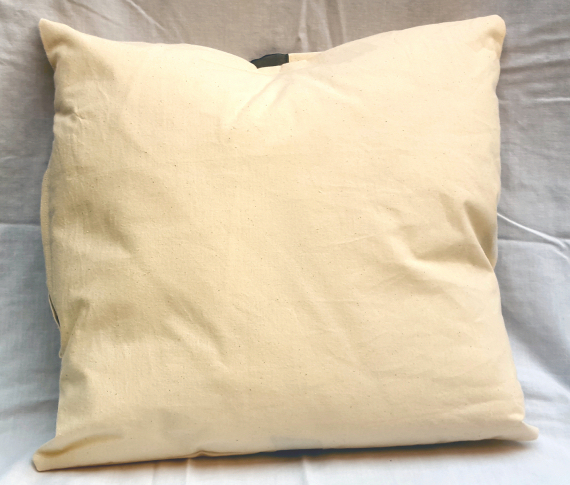 A Natural Calico Cushion with a Bow Design
