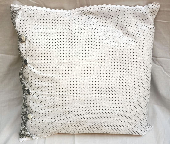 Black Patterned and Spotted Cushion on White with Buttons