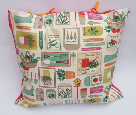 A Handmade Home Garden Design Cushion with Pink reverse and Orange Bows