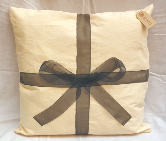 A Natural Calico Cushion with a Bow Design