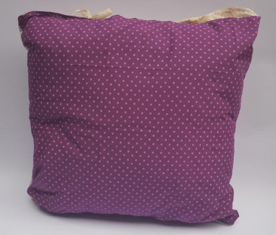 A Floral Pattern Cushion on Cream with a Purple Reverse with Spots, finished with Bows