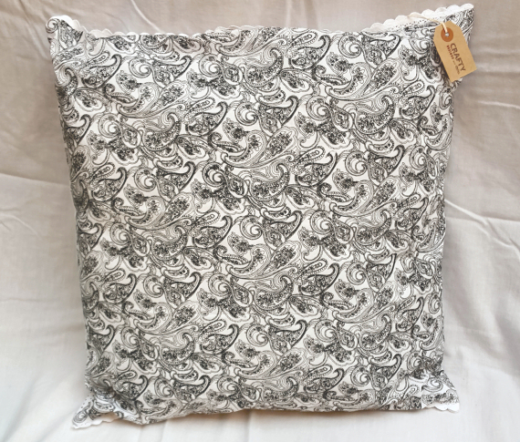 Black Patterned and Spotted Cushion on White with Buttons